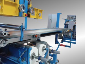 Conveying line with automatic winder for extruded rubber